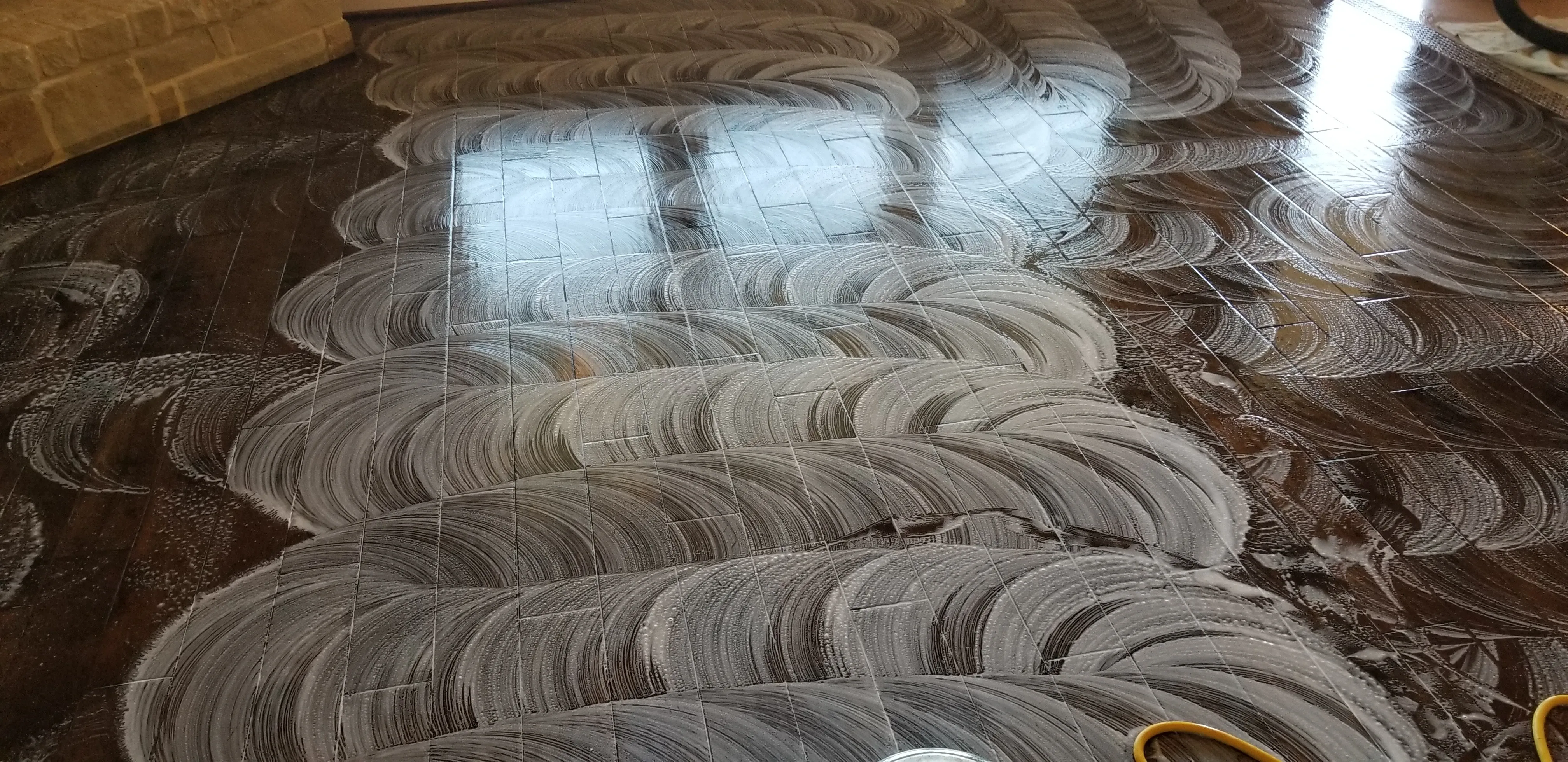Hardwood floor mid-cleaning, showing the process