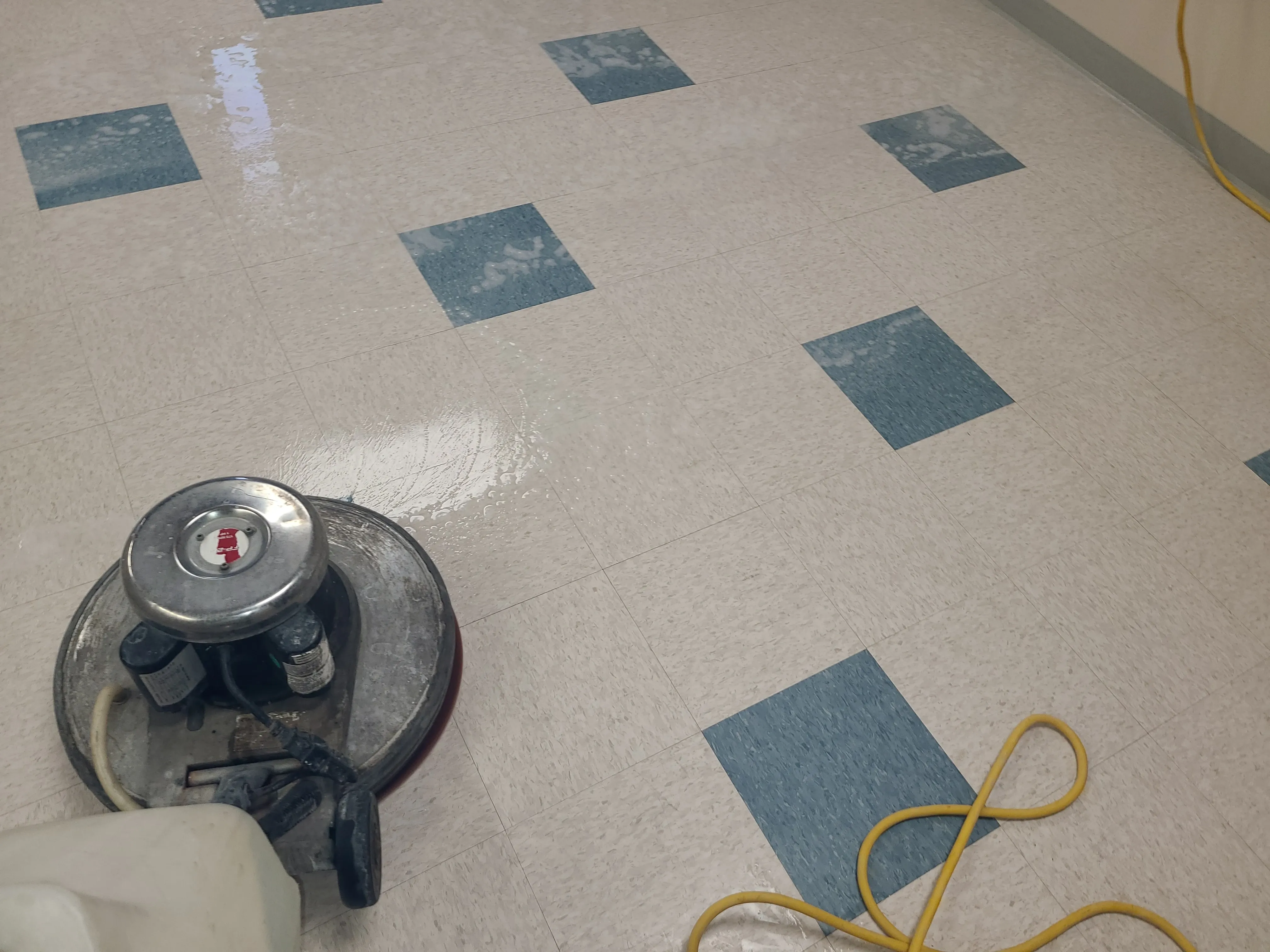 VCT floor mid-strip with the old wax being chemically removed