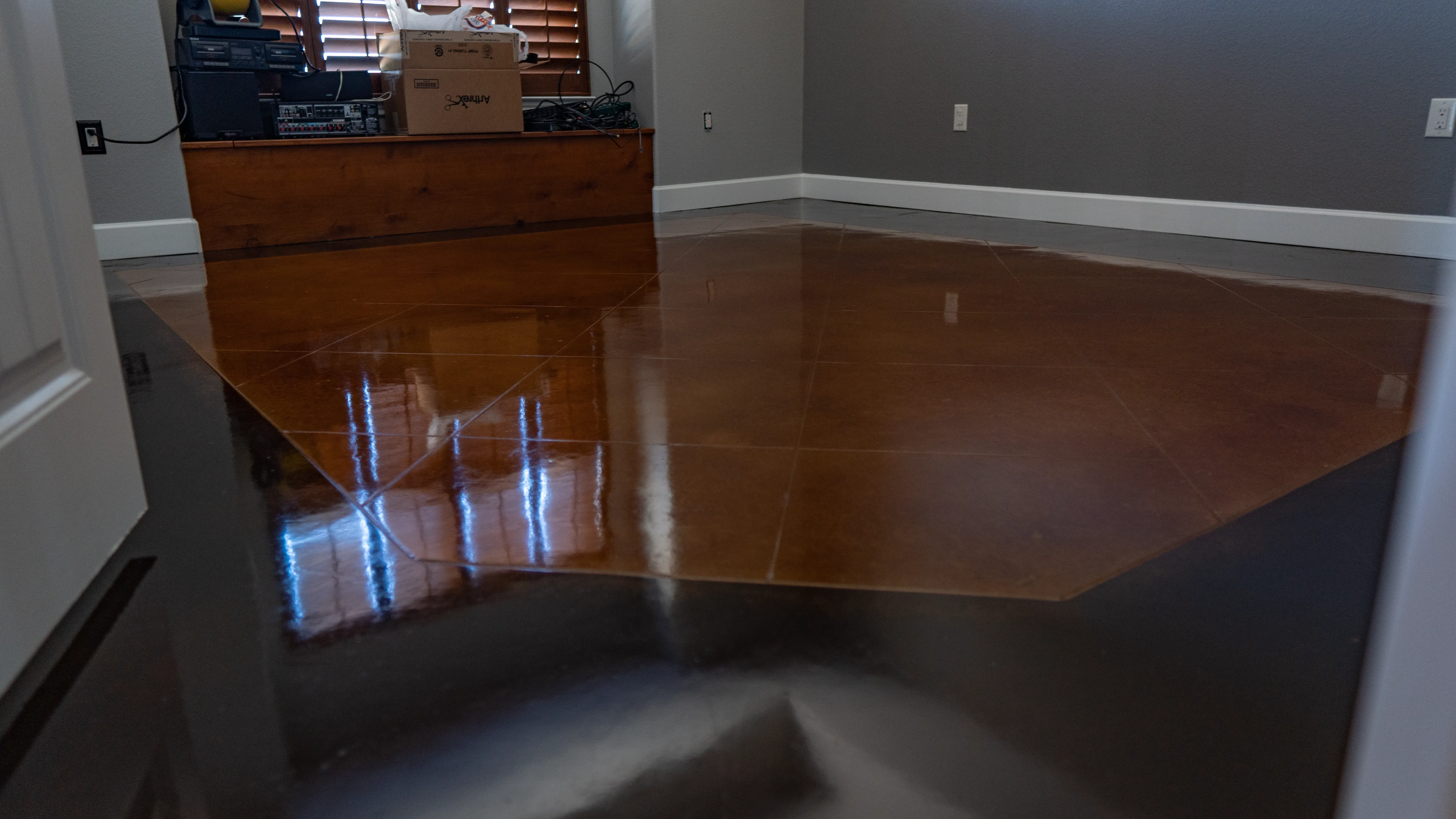 Polished stained concrete floor with a glassy reflective surface