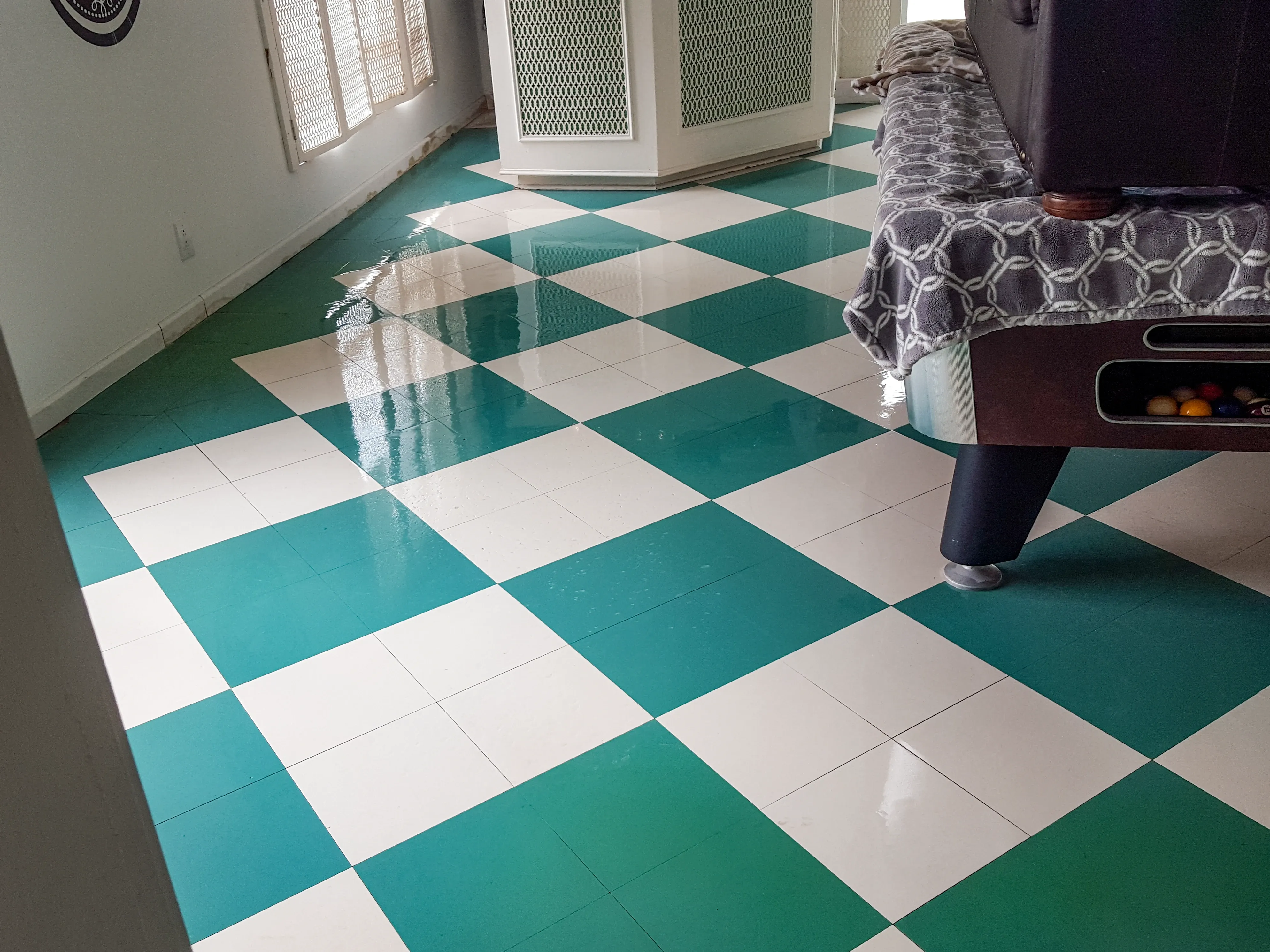 Teal-accented VCT flooring polished to a glossy finish